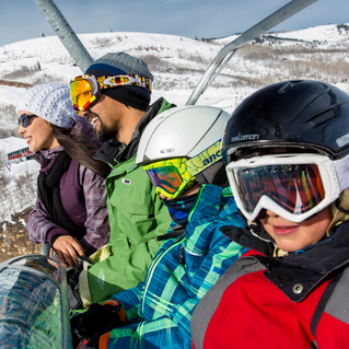 Skiiers riding up mountain